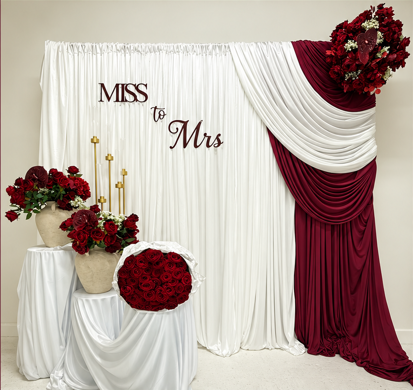 Two-colour bridal draping with a personalised 3D sign, cake stands and floral styling