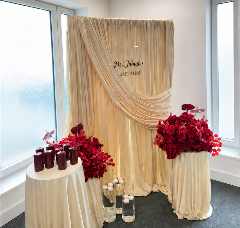 Acrylic welcome sign with champagne draping, cake stands and floral styling