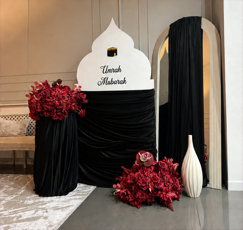 Mosque backdrop with black draping, floral centrepieces and decorative vases